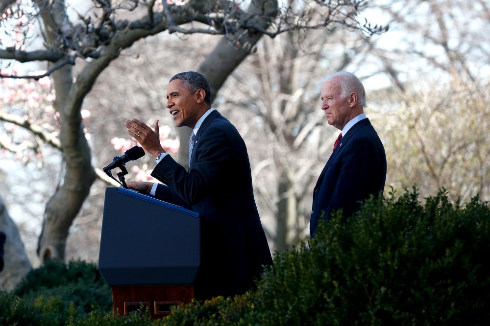 U.S. President Barack Obama (C) speaks about the Affordable Care Act as U.S. Vice President Joe Biden (R) watches in the Rose Garden of the White House on April 1, 2014 in Washington, DC.