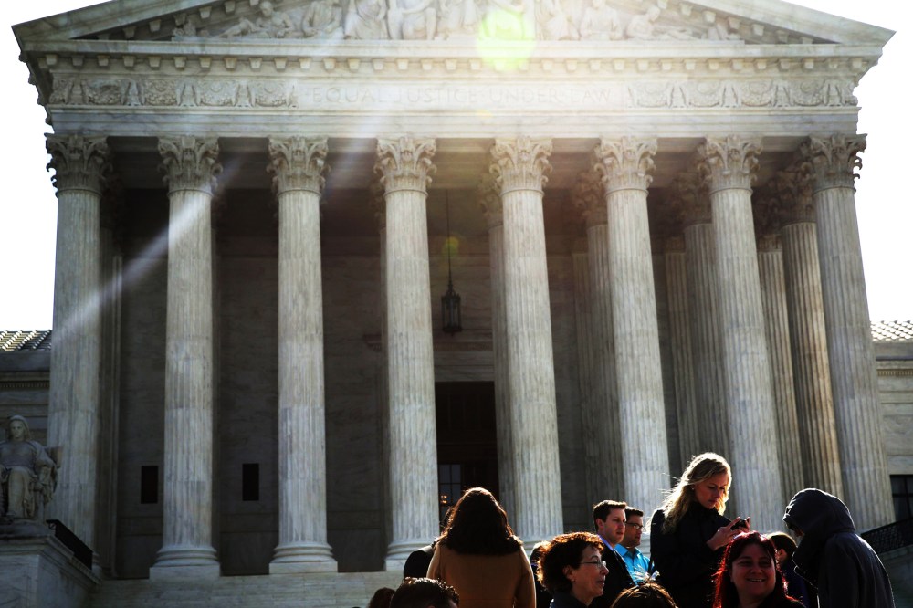 People wait in-line to enter the U.S. Supreme Court to hear oral arguments April 22, 2014 in Washington, DC.