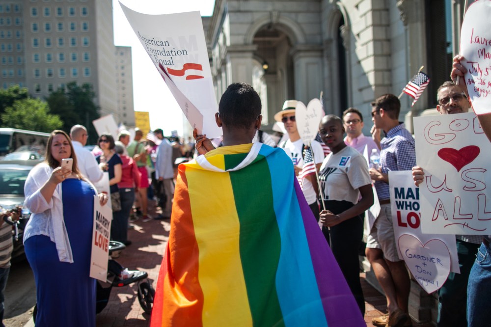 A same-sex marriage supporter wears a rainbow cape behind 4th U.S. Circuit Court of Appeals after a court hearing  May 13, 2014 in Richmond, Virginia.