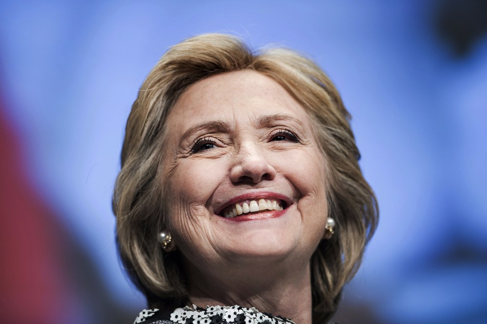 Former Secretary of State Hillary Clinton smiles before speaking at the World Bank May 14, 2014 in Washington, D.C.