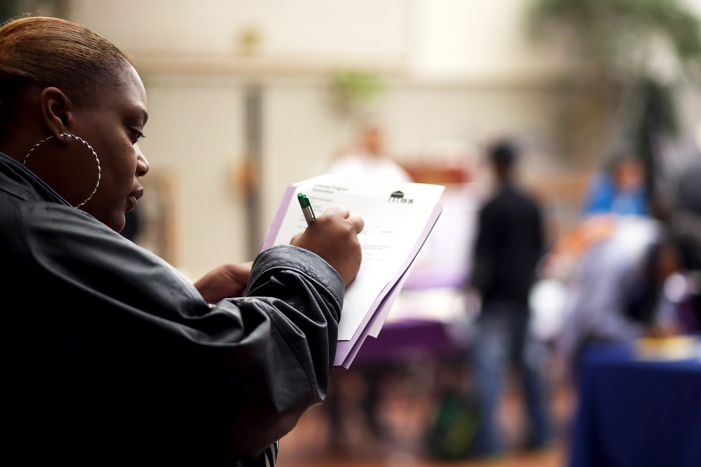 A job seeker fills out an application during a career fair on May 21, 2014 in San Francisco, California.