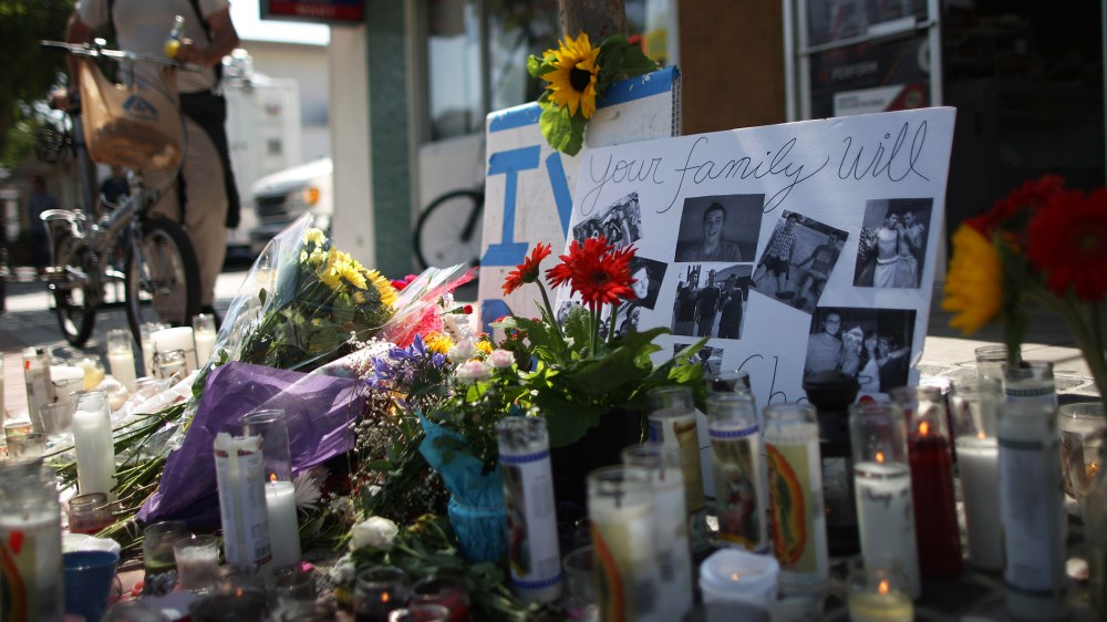 Photos of a victim stand in a makeshift memorial in front of the IV Deli May 25, 2014 in Isla Vista, California.