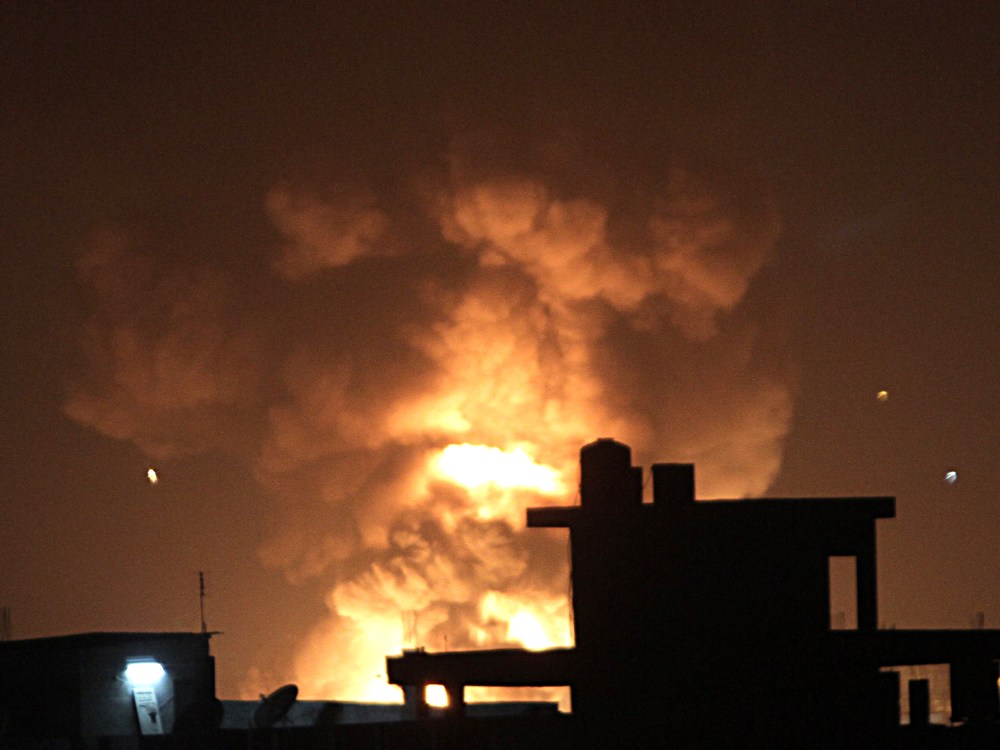 Fire rises during an explosion following an Israeli strike on the border tunnels between Egypt and Rafah in the southern Gaza Strip on November 20, 2012. US Secretary of State Hillary Clinton vowed to support Israeli security on November 20 while...