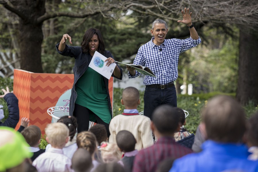 President Barack Obama and first lady Michelle Obama gesture as they read from the book 