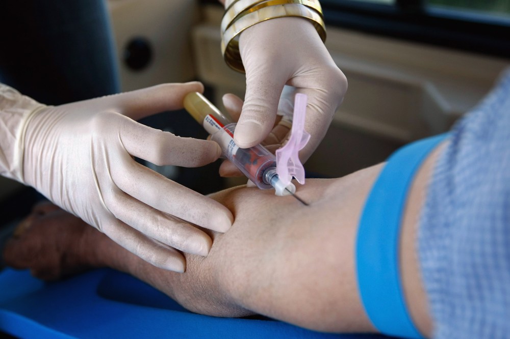 A health worker draws blood from a patient in Denver, Colorado.
