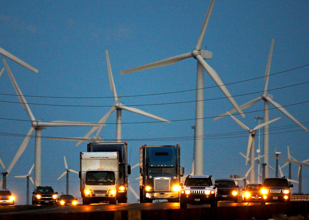 Diesel trucks and cars pass windmills along the 10 freeway near Banning, California.