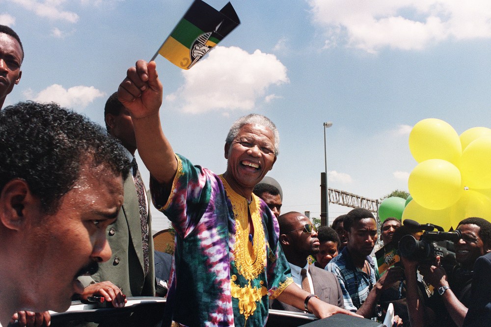 Nelson Mandela waves to supporters while campaigning for the presidential election, Jan. 29, 1994.