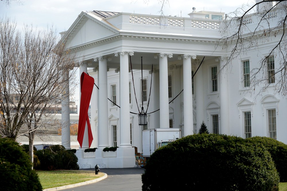 A red ribbon is displayed on the North Portico of the White House, December 1, 2014, to commemorate World AIDS Day.