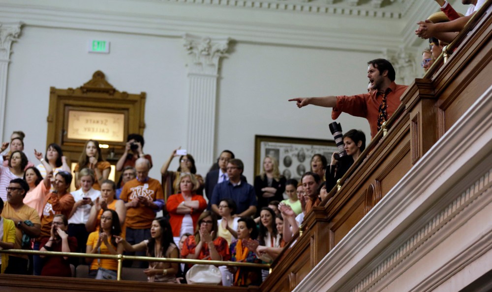 Members of the gallery cheer and chant as the Texas Senate tries to bring an abortion bill to a vote as time expires, Wednesday, June 26, 2013, in Austin, Texas.