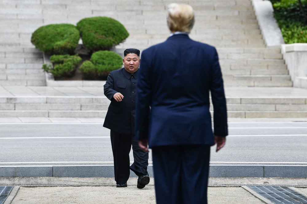 North Korea's leader Kim Jong Un walks to greet Donald Trump at the Military Demarcation Line that divides North and South Korea, in the Joint Security Area (JSA) of Panmunjom in the Demilitarized zone (DMZ) on June 30, 2019.
