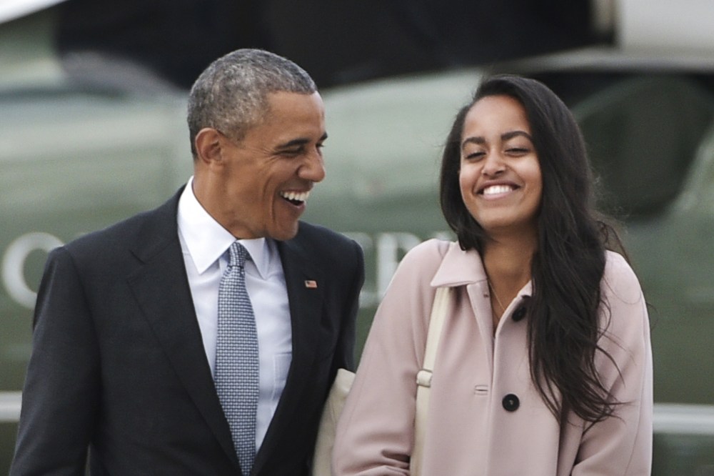This file photo taken on April 7, 2016 shows President Barack Obama and daughter Malia make their way to board Air Force One. (Photo by Mandel Ngan/AFP/Getty)