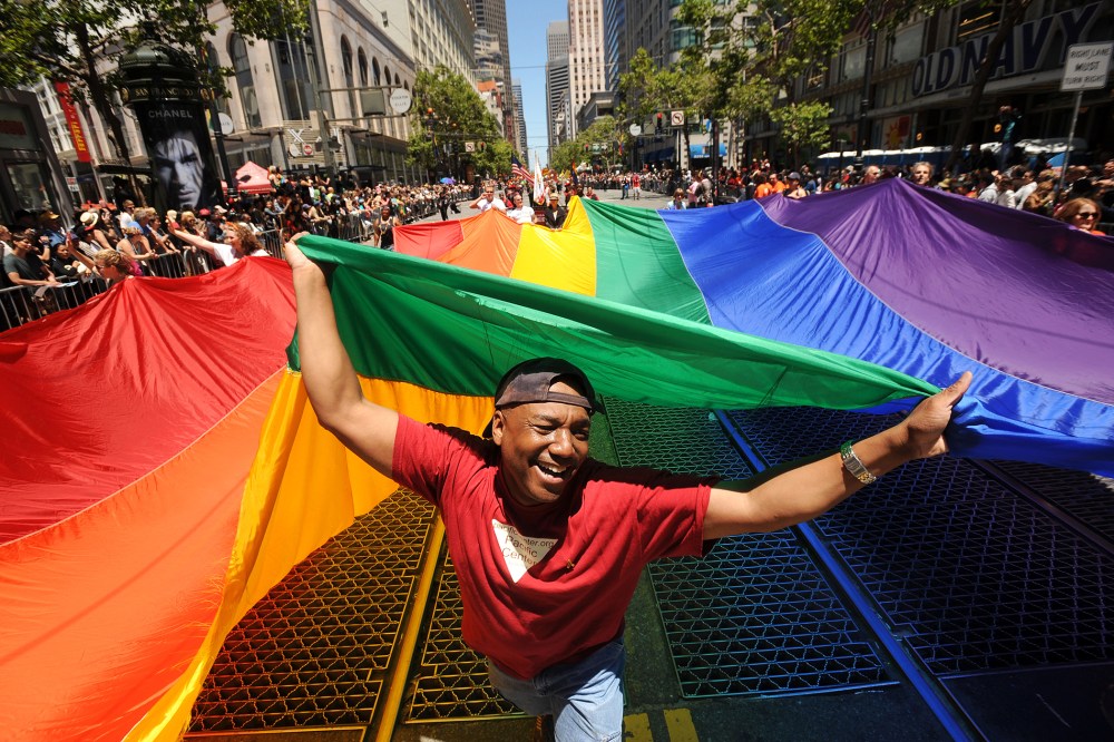 Mark Wilson carries a rainbow flag during San Francisco's 42nd annual gay pride parade, June 24, 2012.