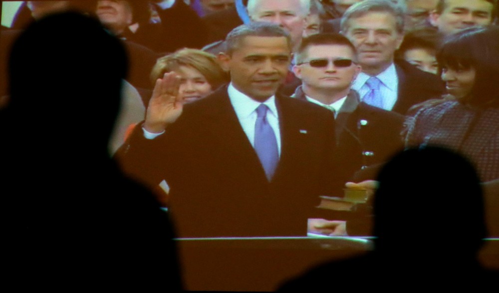 Visitors to the Brown v. Board of Education National Historic Site watch a broadcast of the inauguration of President Barack Obama Monday, Jan. 21, 2013, in Topeka, Kan. (AP Photo/Charlie Riedel)