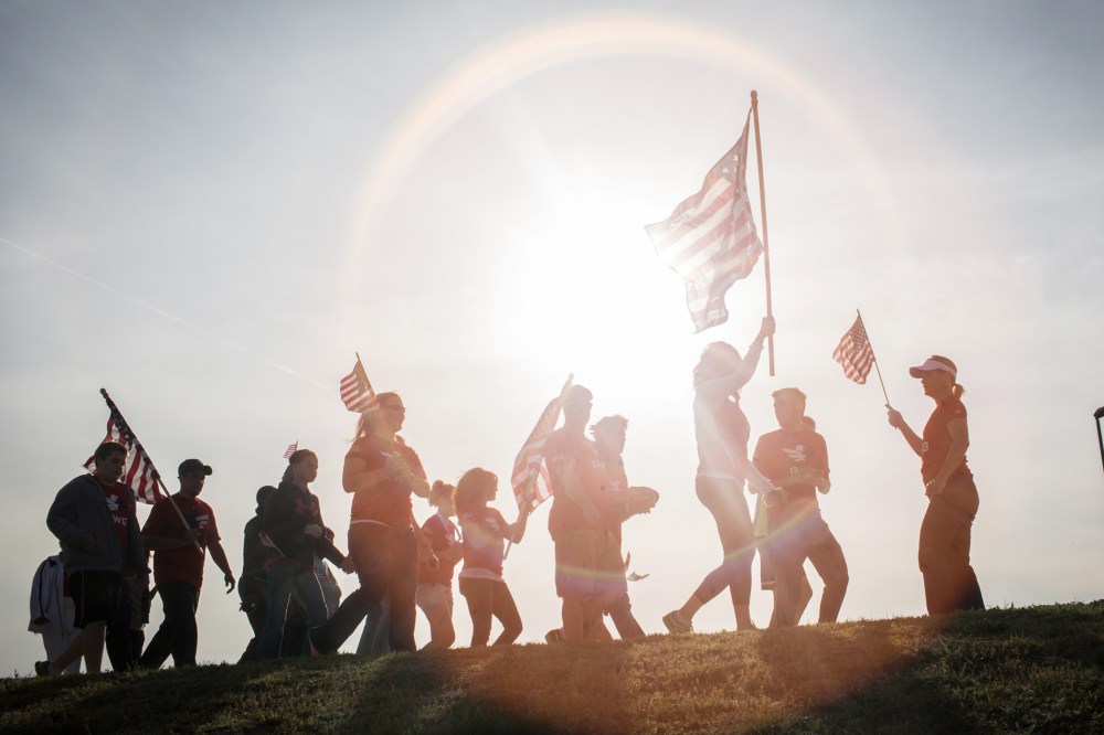 Active members of the military, veterans and civilians march to pay tribute to the victims and families affected by the Fort Hood shooting, April 4, 2014, in Killeen, Texas.