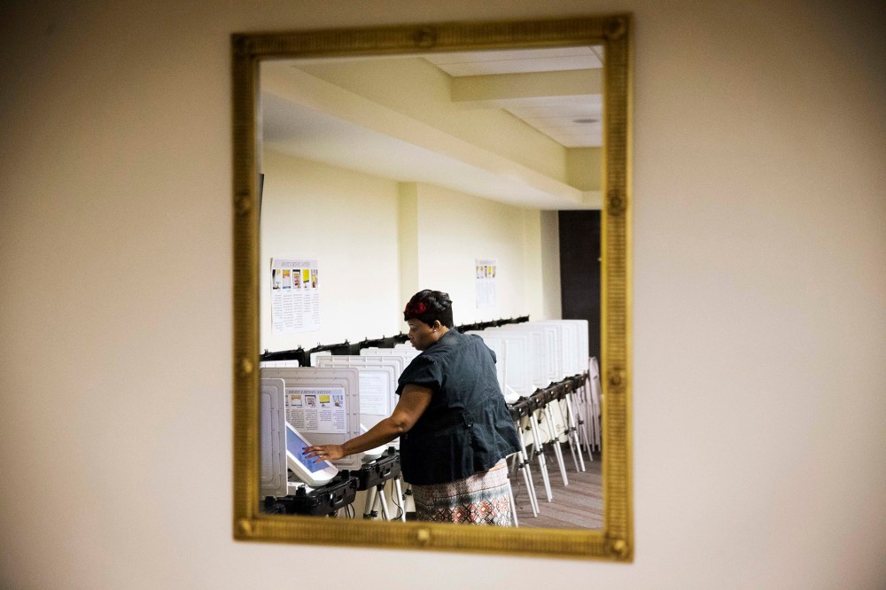 Tameika Ogburn, a polling site assistant manager, prepares voting machines before a voting location opens for Georgia's primary election, March 1, 2016, in Atlanta. (Photo by David Goldman/AP)