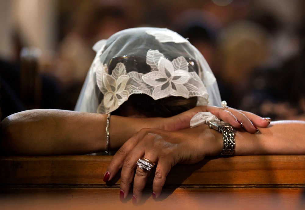 A Coptic Christian grieves during prayers for the departed, remembering the victims of Thursday's crash of EgyptAir flight 804, at Al-Boutrossiya Church, the main Coptic Cathedral complex, in Cairo, Egypt, May 22, 2016. (Photo by Amr Nabil/AP)