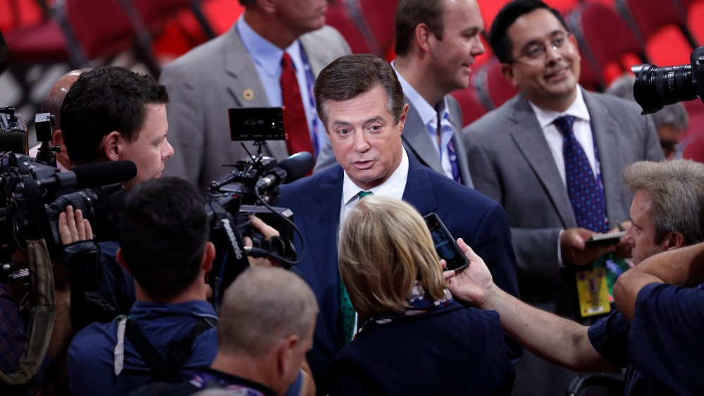 Trump Campaign Chairman Paul Manafort is surrounded by reporters on the floor of the Republican National Convention in Cleveland. (Photo by J. Scott Applewhite/AP)