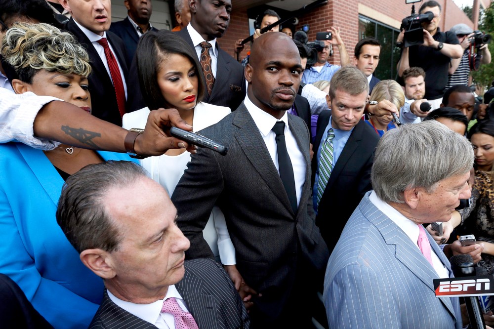 Minnesota Vikings running back Adrian Peterson, center, stands outside the courthouse after making his first court appearance, Oct. 8, 2014, in Conroe, Texas. (Photo by David J. Phillip/Pool/AP)