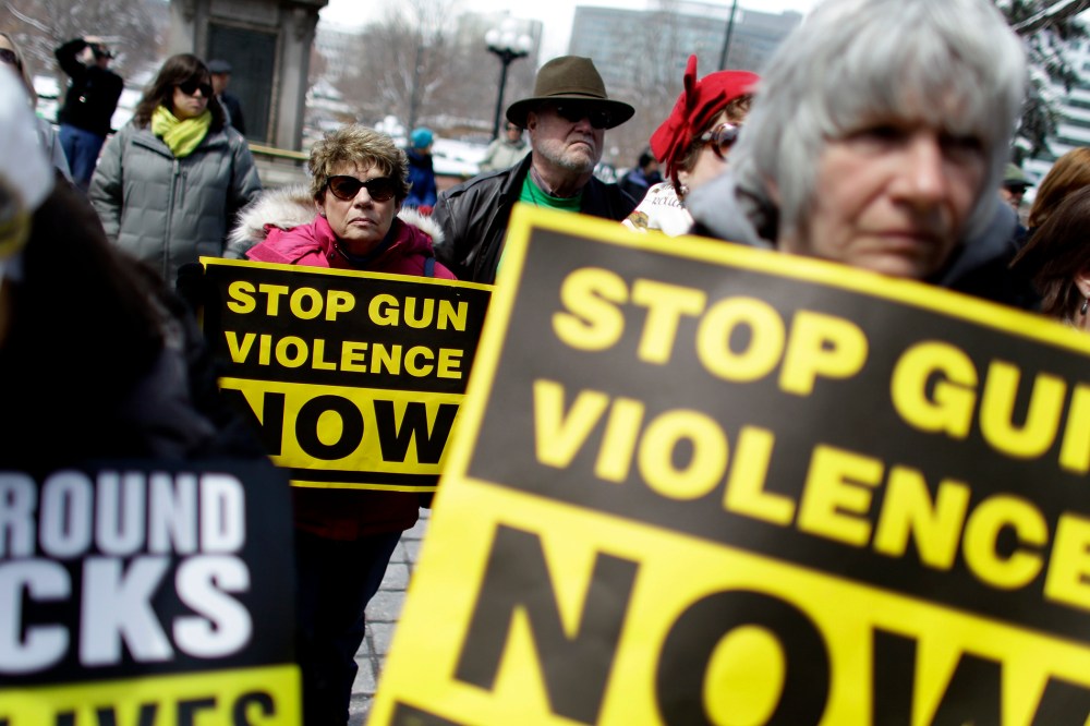 Community gun safety advocates and members of the public hold signs during a rally and vigil to honor victims of gun violence, sponsored by Colorado Ceasefire, on the steps of the Colorado State Capitol, in Denver, Thursday April 18, 2013.