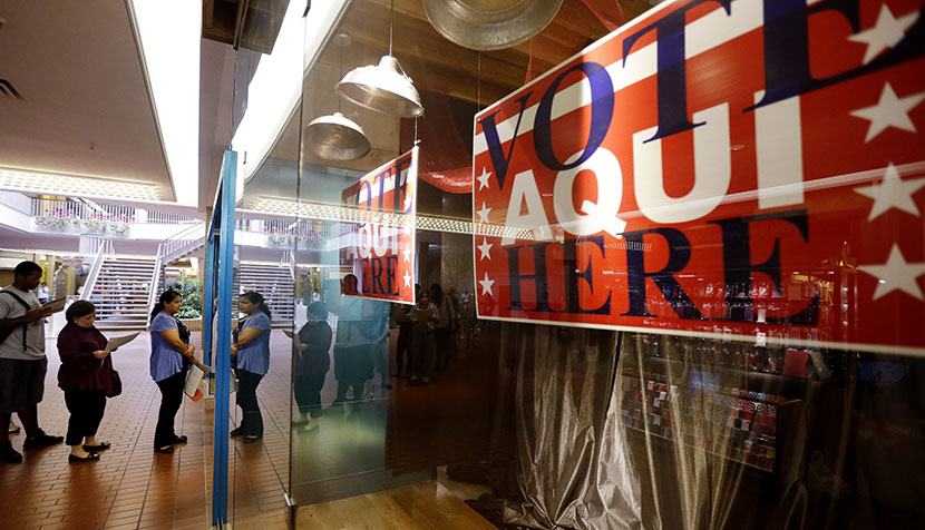Voters wait in line at a polling place located inside a shopping mall on Election Day, Tuesday, Nov. 6, 2012, in Austin, Texas. (Photo by Eric Gay/AP)