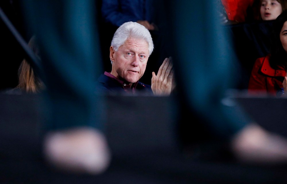 Former President Bill Clinton listens to Democratic presidential candidate Hillary Clinton speak during a rally, Feb. 19, 2016, in Las Vegas. (Photo by John Locher/AP)