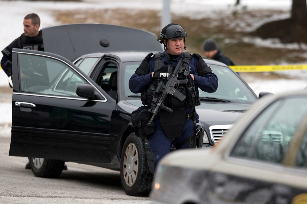 Police walk on the scene after a shooting at The Mall in Columbia on Jan. 25, 2014 in Columbia, Md.