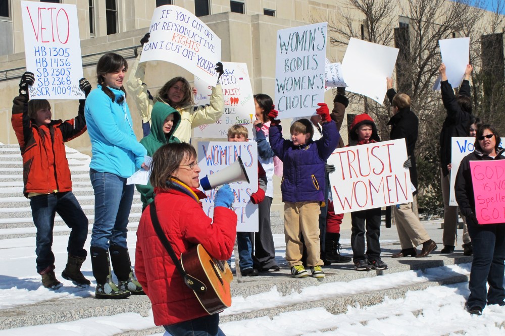In this March 25, 2013, file photo Kris Kitko, left, leads chants of protest at an abortion-rights rally at the state Capitol in Bismarck, N.D. (Photo by James MacPherson/AP)
