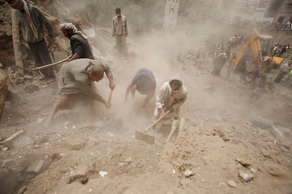 People search for survivors under the rubble of houses destroyed by Saudi airstrikes in the old city of Sanaa, Yemen, June 12, 2015. (Photo by Hani Mohammed/AP)