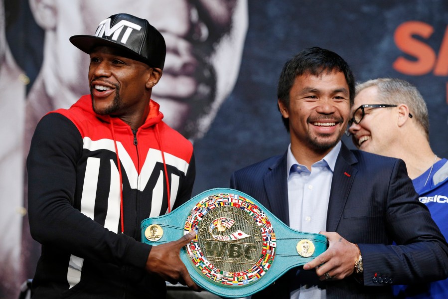 Boxers Floyd Mayweather Jr., left, and Manny Pacquiao pose with a WBC belt during a press conference, April 29, 2015, in Las Vegas. (Photo by John Locher/AP)