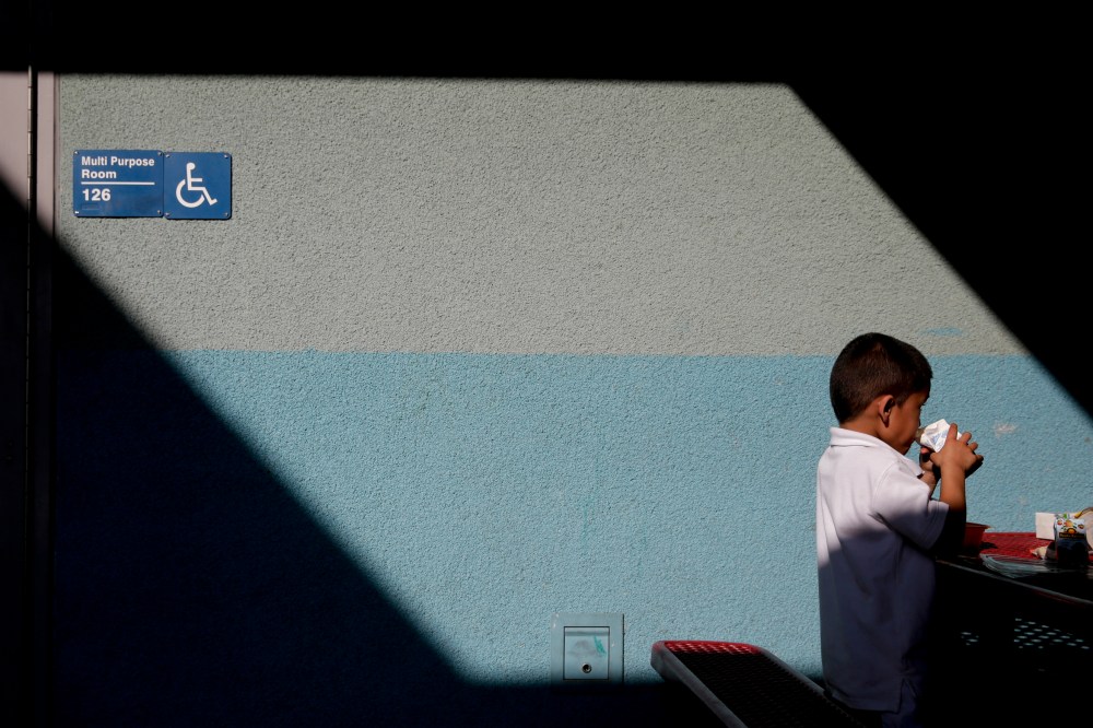 Joshua Beltran, 5, drinks his milk at Kingsley Elementary School, Jan. 13, 2015, in Los Angeles. Many of the students at the school in a low-income neighborhood of Los Angeles eat breakfast and lunch provided by the school. (Photo by Jae C. Hong/AP)