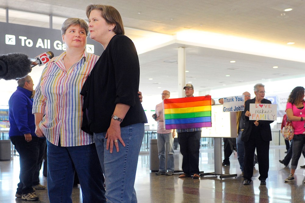 Sharon Baldwin, left, and her partner Mary Bishop speak with members of the media before boarding a plane to Denver at Tulsa International Airport, on April 16, 2014.