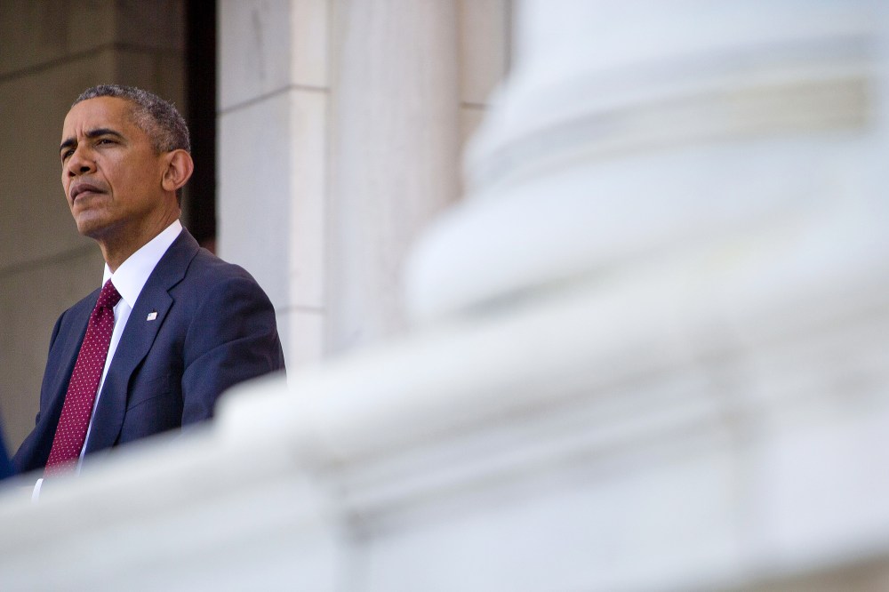 President Barack Obama listens as Defense Secretary Ash Carter speaks in the Memorial Amphitheater at Arlington National Cemetery in Arlington, Va., on May 25, 2015. (Photo by Pablo Martinez Monsivais/AP)