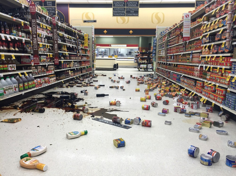 Items fallen from the shelves litter the aisles inside a Safeway grocery store following a magnitude 6.8 earthquake on the Kenai Peninsula, Jan. 24, 2016, in south-central Alaska. (Photo by Vincent Nusunginya/AP)