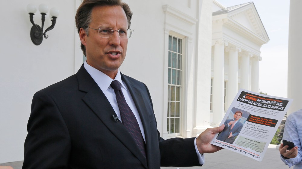 Seventh District US Congressional Republican candidate, David Brat displays an immigration mailer by Congressman Eric Cantor during a press conference at the Capitol in Richmond, Va., Wednesday, May 28, 2014.