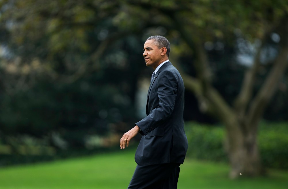 President Barack Obama walks on the South Lawn as he leaves the White House in Washington, Wednesday, Oct. 30, 2013, for a trip to Boston.