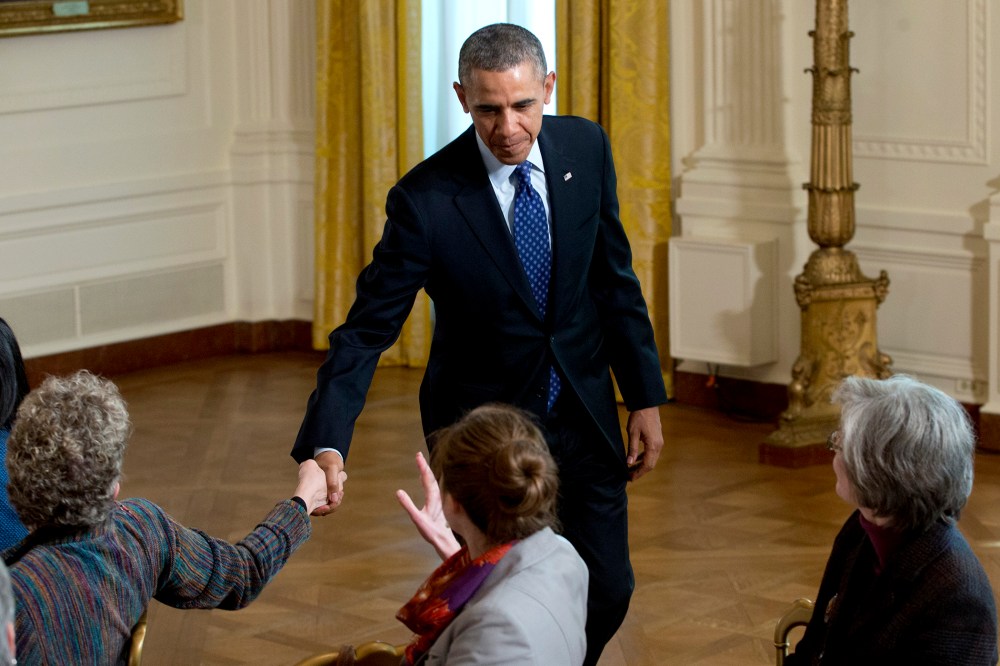 President Barack Obama shakes hands as he leaves the East Room of the White House in Washington, Jan. 22, 2014.