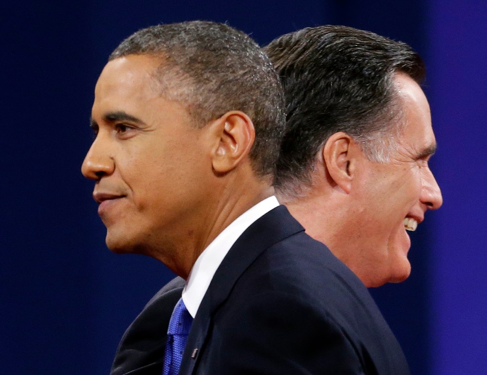 Republican presidential candidate, former Massachusetts Gov. Mitt Romney and President Barack Obama walk past each other on stage at the end of the last debate at Lynn University, Monday, Oct. 22, 2012, in Boca Raton, Fla. (AP Photo/Pablo Martinez...