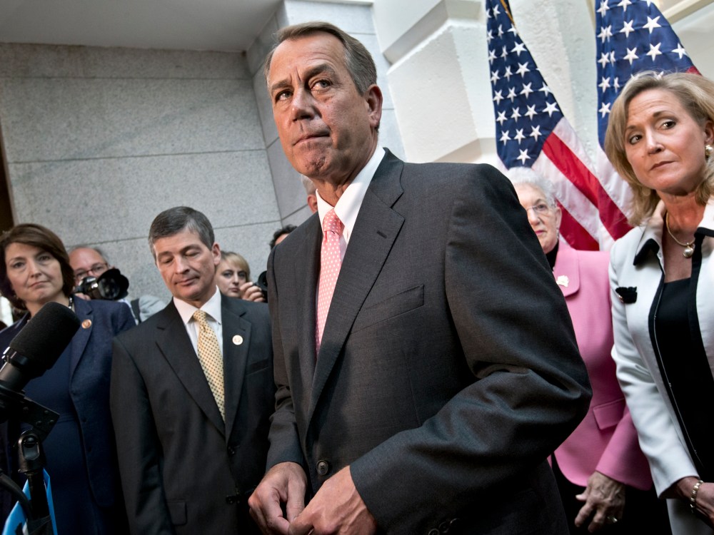 Speaker of the House John Boehner, R-Ohio, joined by fellow Republicans, emerges from a closed-door GOP meeting