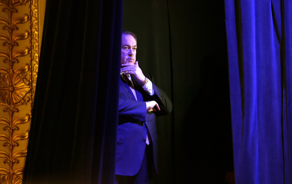 Former Arkansas Gov. Mike Huckabee waits backstage before speaking during the Freedom Summit, Jan. 24, 2015, in Des Moines, Iowa. (Photo by Charlie Neibergall/AP)