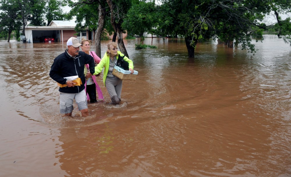 An elderly woman and her pets were rescued from her home on farm to market road 367, west of Wichita Falls, Texas, May 20, 2015. (Photo by Torin Halsey/Times Record News/AP)