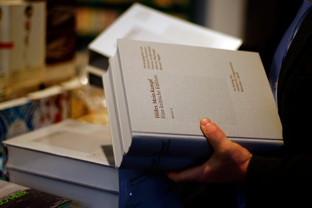 A books store clerk places the publication of "Hitler, Mein Kampf - A critical edition" in a book store in Munich, Germany, Jan. 8, 2016. (Photo by Matthias Schrader/AP)