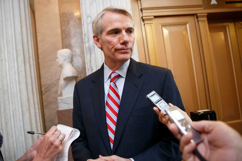 Sen. Rob Portman, R-Ohio, center, speaks with reporters in Washington, D.C., May 12, 2014. (Photo by AP)