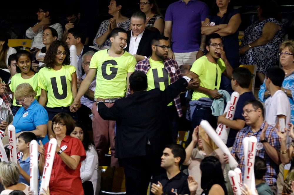 Immigration reform protestors are led outside after they interrupted a speech by former Florida Gov. Jeb Bush as he announces his bid for the Republican presidential nomination, at Miami Dade College, June 15, 2015, in Miami. (Photo by Lynne Sladky/AP)