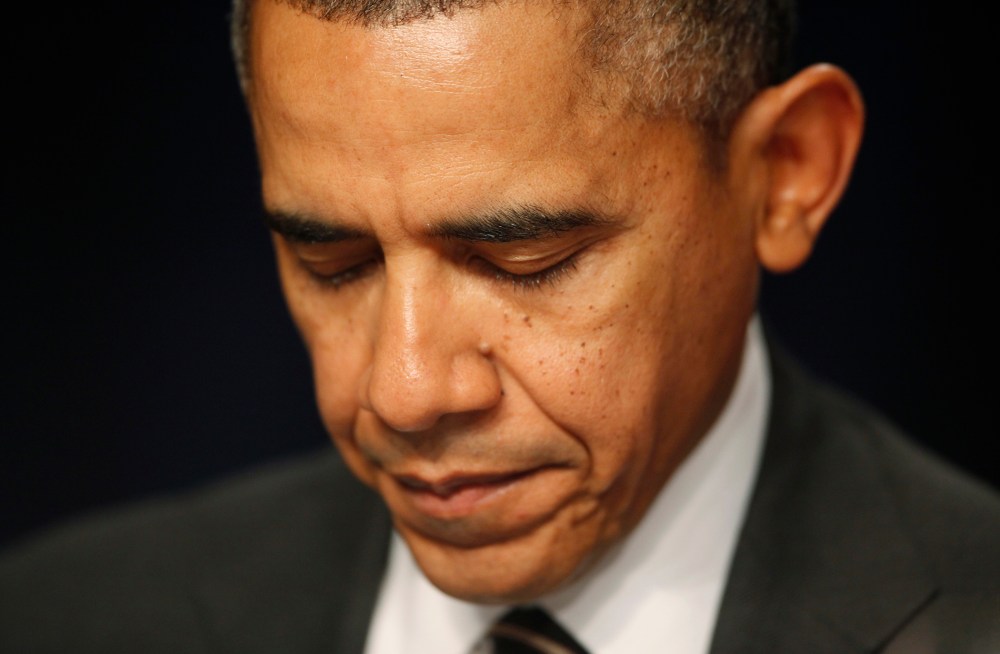 President Barack Obama closes his eyes as a prayer is offered at the National Prayer Breakfast in Washington, Feb. 6, 2014.