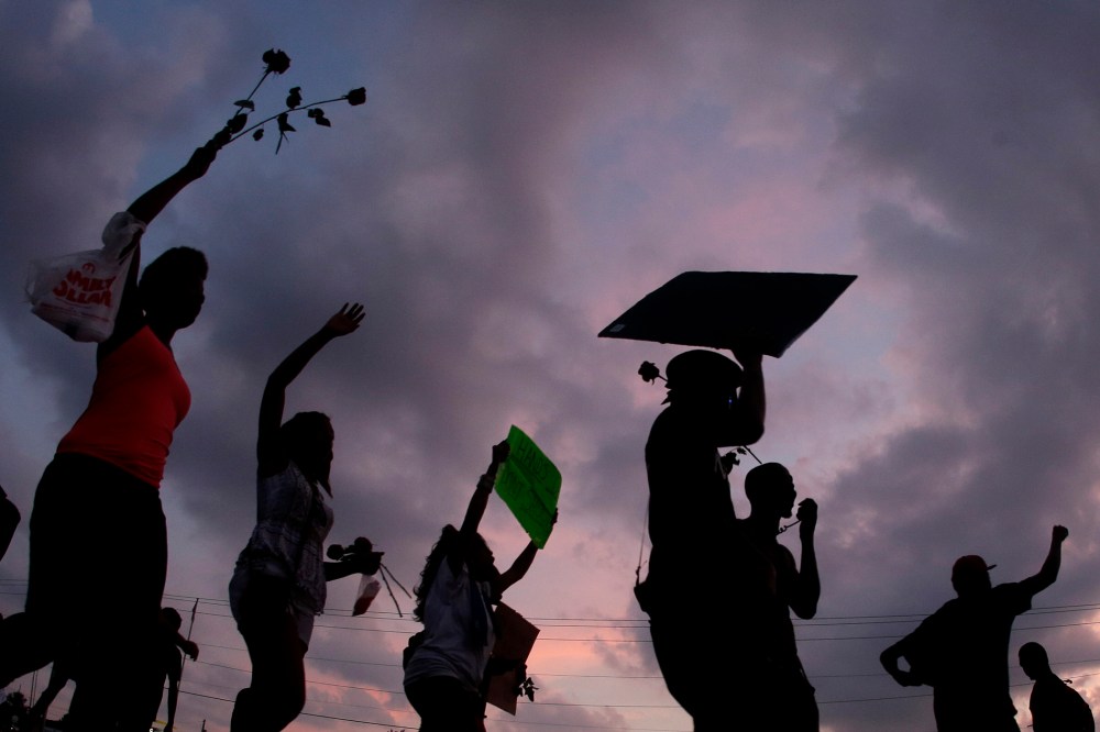 People protest for Michael Brown, who was killed by a police officer Aug. 9 in Ferguson, Mo on Aug. 18, 2014. (Photo by Charlie Riedel/AP)