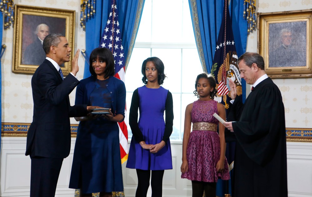 President Barack Obama is officially sworn-in by Chief Justice John Roberts in the Blue Room of the White House during the 57th Presidential Inauguration in Washington, Sunday Jan. 20, 2013. Next to Obama are first lady Michelle Obama, holding the...
