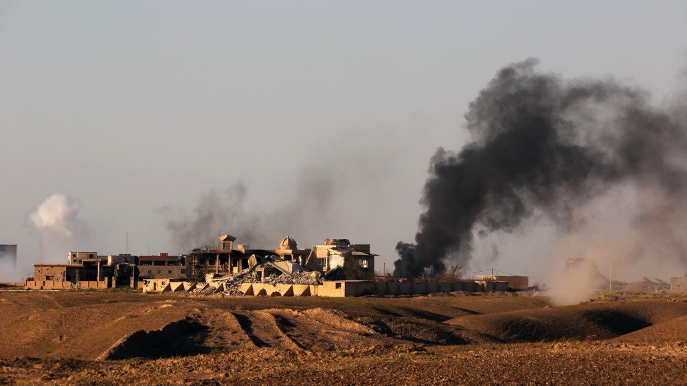 Smoke rises from central Tikrit during clashes between Iraqi security forces and Islamic State group extremists in Tikrit, 130 kilometers (80 miles) north of Baghdad, Iraq, March 26, 2015. (Photo by Khalid Mohammed/AP)
