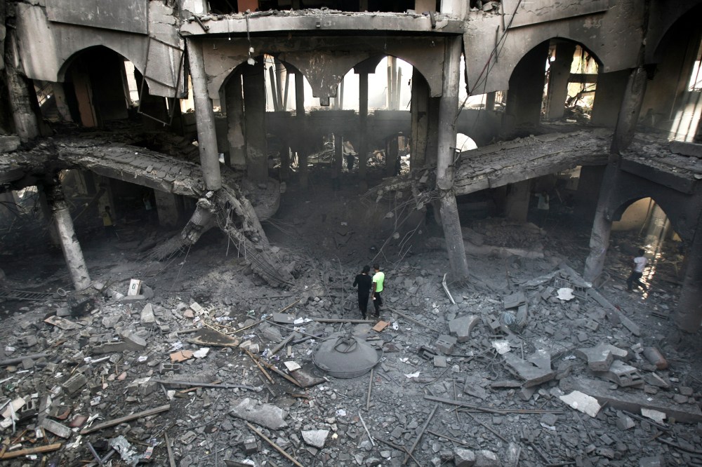 Palestinians inspect the damage of a Rafah commercial center after an Israeli strike in Rafah, in the southern Gaza Strip, Aug. 24, 2014. (Photo by Eyad Baba/AP)