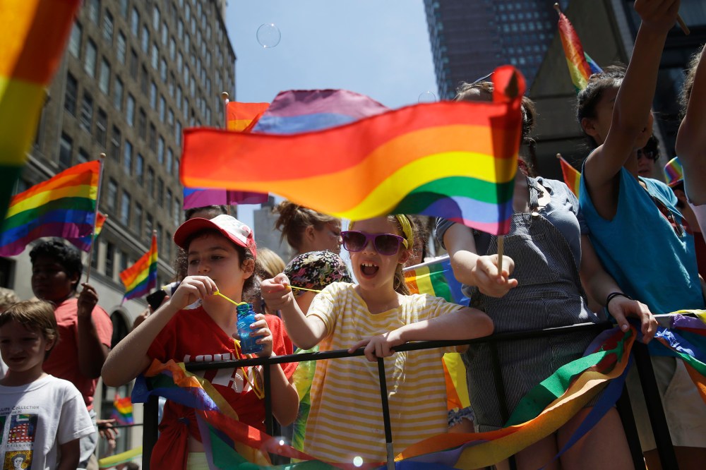 Children blow bubbles as they pass by on a float in the Gay Pride Parade in New York on June 29, 2014. (Photo by Seth Wenig/AP)