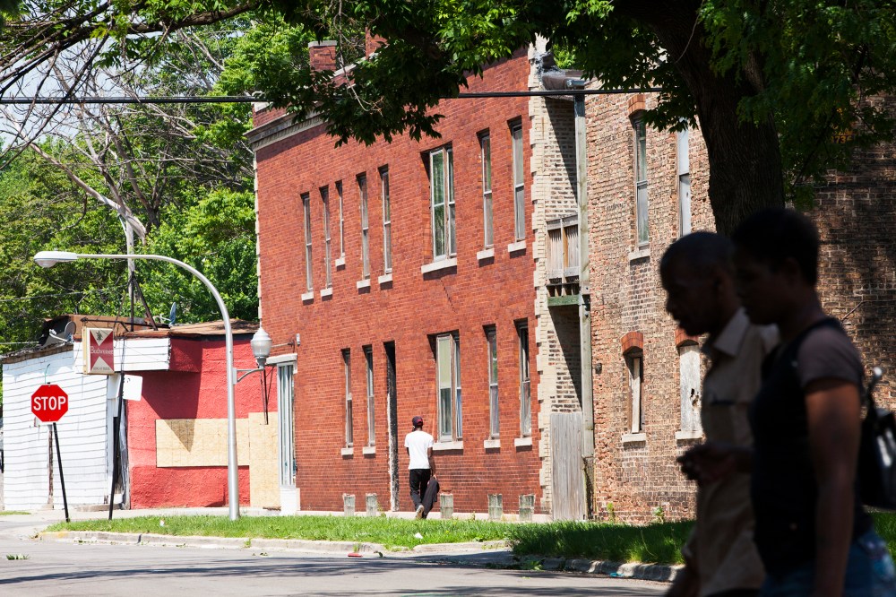 People walk through the Englewood neighborhood, on June 9, 2014 in Chicago, Illinois.